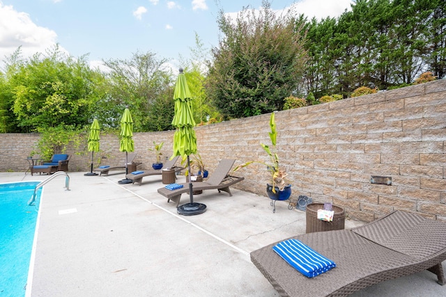 view of patio / terrace featuring a fenced in pool