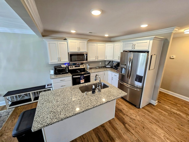 kitchen with sink, white cabinetry, stainless steel appliances, ornamental molding, and light hardwood / wood-style flooring