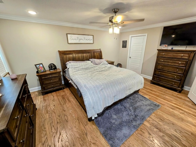 bedroom featuring ceiling fan, ornamental molding, and light wood-type flooring