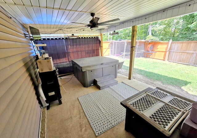 view of patio with ceiling fan and a hot tub