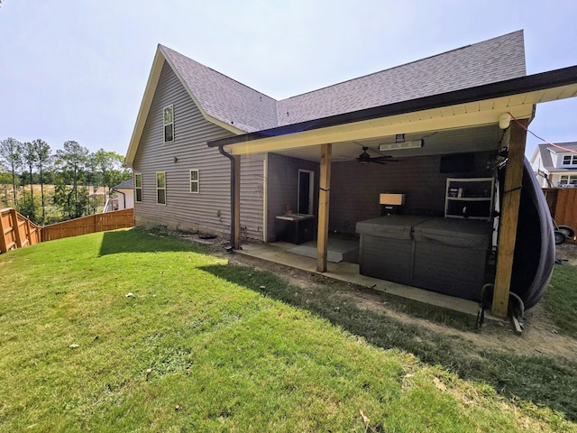 back of property featuring a yard, a patio area, and ceiling fan