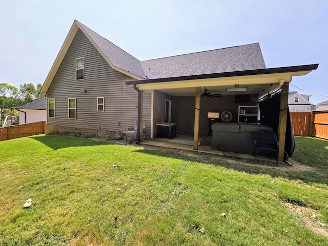 back of property with a yard, a patio, and ceiling fan