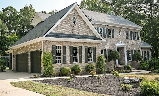 view of front of house with an attached garage, crawl space, concrete driveway, and brick siding