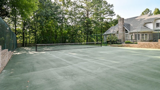 view of tennis court with fence