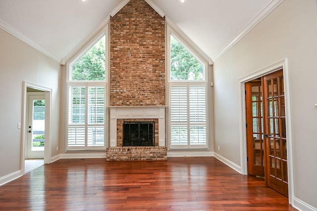 unfurnished living room with ornamental molding and dark hardwood / wood-style floors