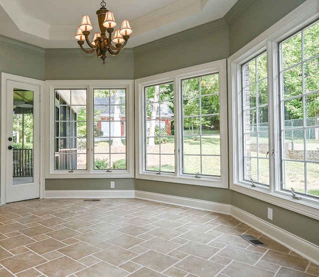 unfurnished sunroom with a wealth of natural light, a raised ceiling, and a notable chandelier