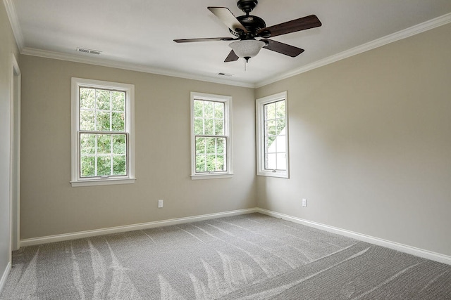 carpeted empty room featuring visible vents, crown molding, baseboards, and ceiling fan