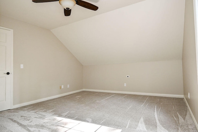 bonus room featuring light carpet, ceiling fan, vaulted ceiling, and baseboards