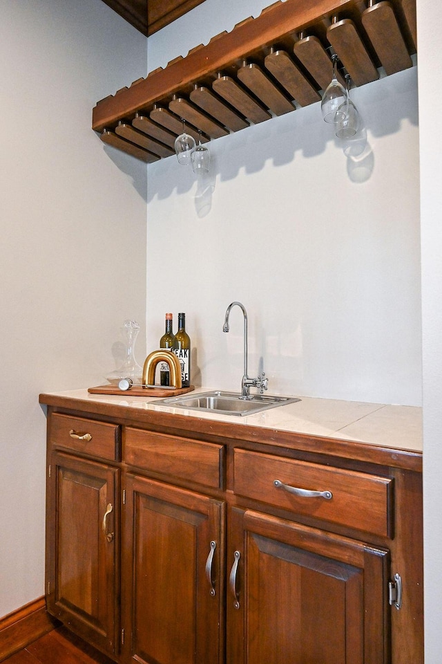 bar with indoor wet bar and a sink