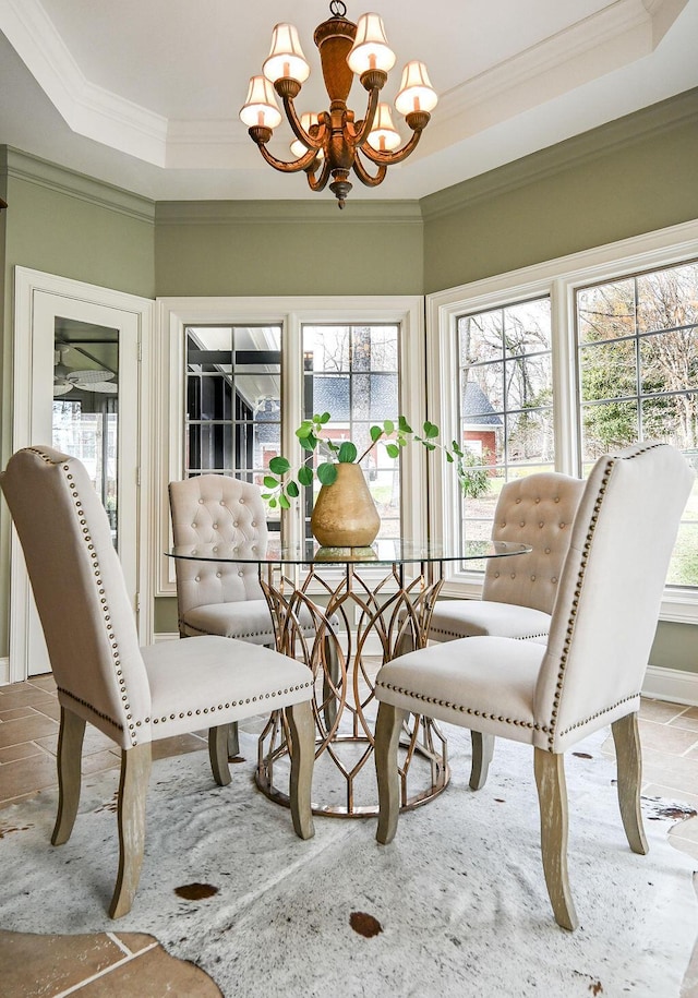 sunroom with a chandelier and a tray ceiling