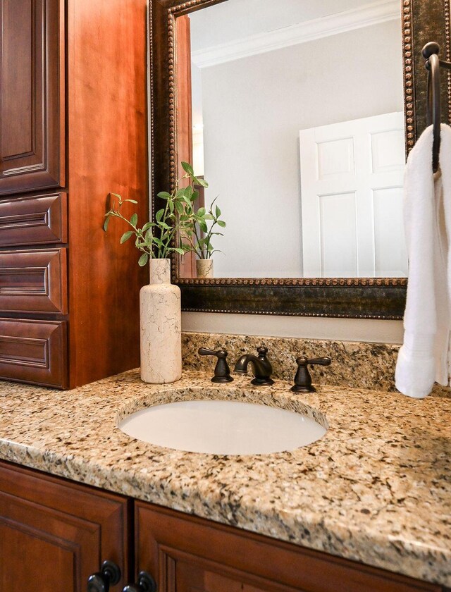 bathroom featuring vanity and crown molding