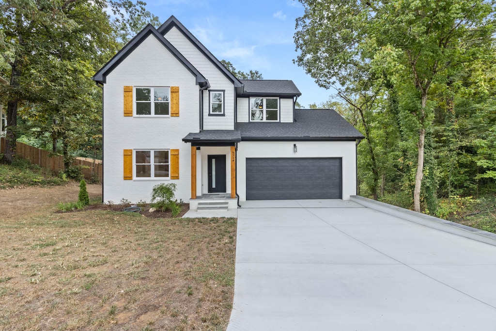 view of front of property with a front yard and a garage