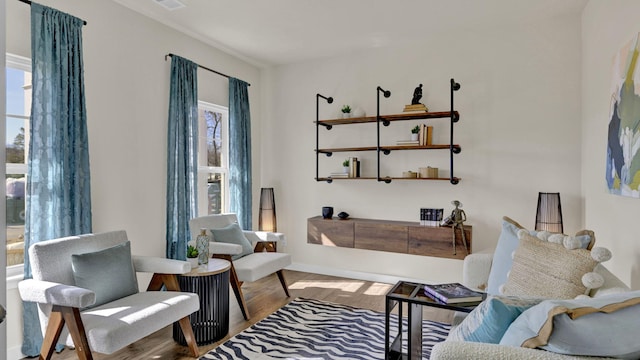 sitting room with hardwood / wood-style flooring