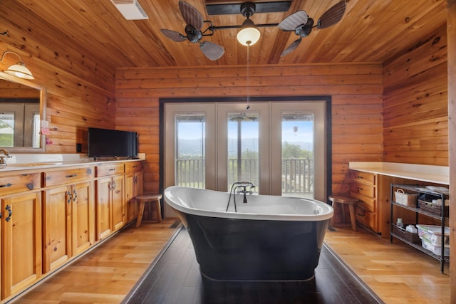 kitchen with plenty of natural light, light wood-style flooring, and wood ceiling