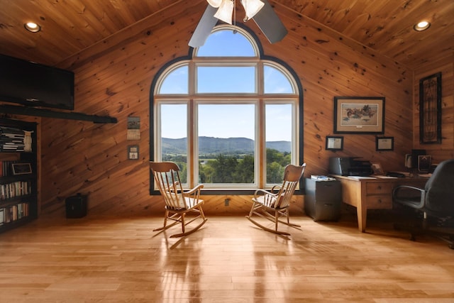 sitting room featuring light wood-type flooring, wood ceiling, and a mountain view