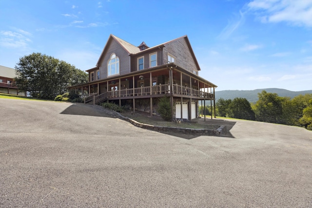 view of front facade featuring a mountain view and a garage