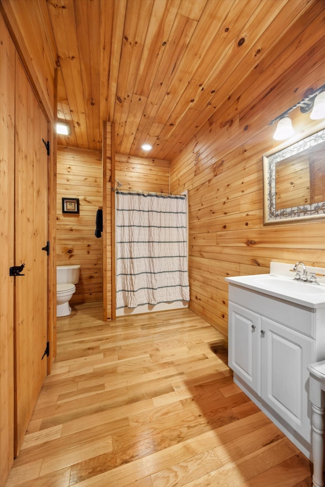 bathroom featuring toilet, wood finished floors, wooden ceiling, and wood walls