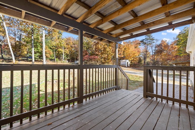 wooden terrace with a yard and a storage shed