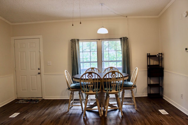 dining area with ornamental molding, a textured ceiling, and dark hardwood / wood-style flooring