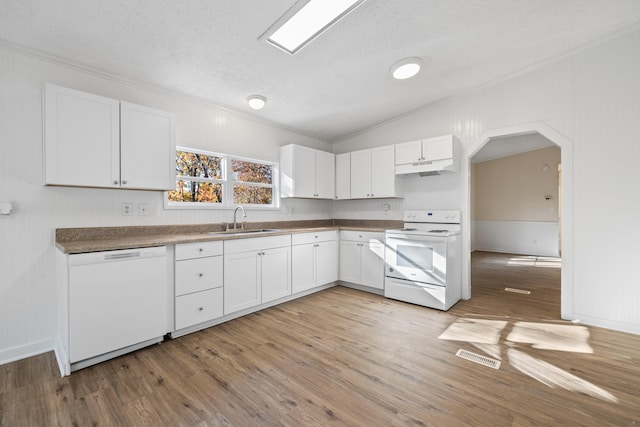 kitchen featuring white appliances, sink, light wood-type flooring, and white cabinets