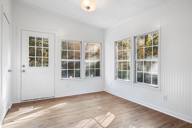 unfurnished sunroom featuring lofted ceiling