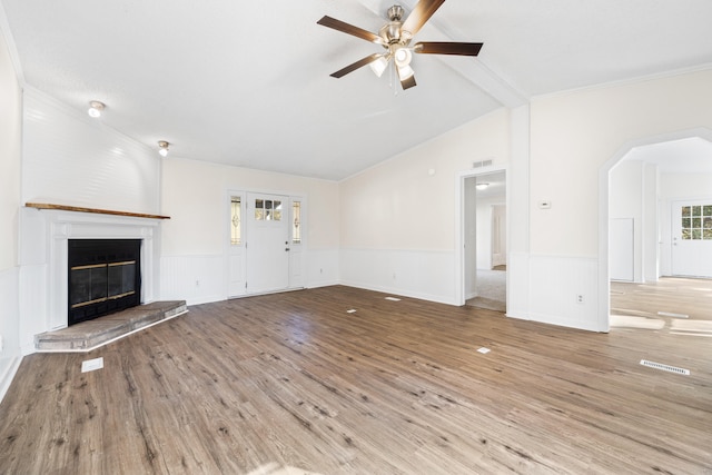 unfurnished living room featuring crown molding, lofted ceiling with beams, light wood-type flooring, and ceiling fan