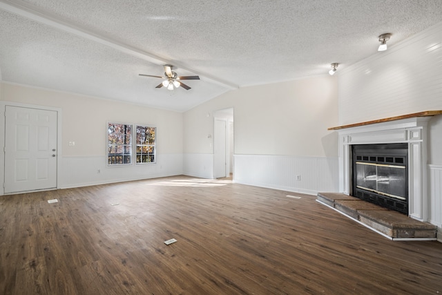 unfurnished living room with ceiling fan, a textured ceiling, vaulted ceiling with beams, dark hardwood / wood-style floors, and a fireplace