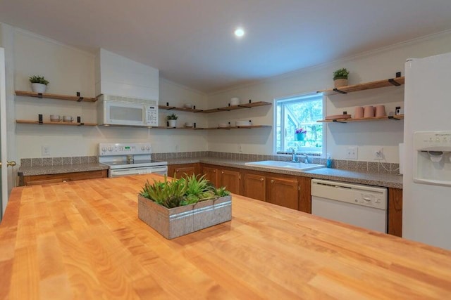 kitchen featuring butcher block countertops, white appliances, sink, and vaulted ceiling