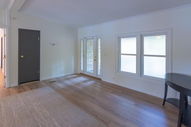 spare room featuring light hardwood / wood-style floors and ornamental molding