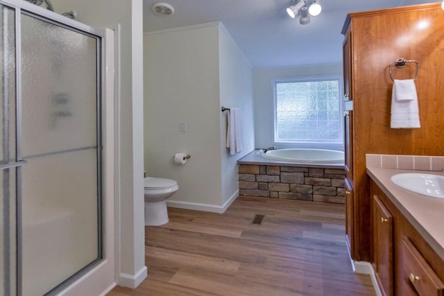 full bathroom with toilet, plus walk in shower, hardwood / wood-style floors, ornamental molding, and vanity