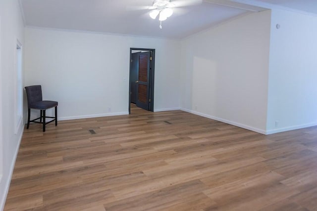 spare room featuring hardwood / wood-style floors, ceiling fan, and crown molding