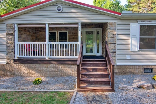 view of exterior entry featuring a porch