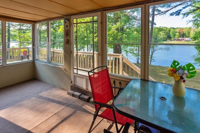 sunroom / solarium featuring a water view and a wealth of natural light