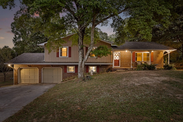 tri-level home with a yard and a garage