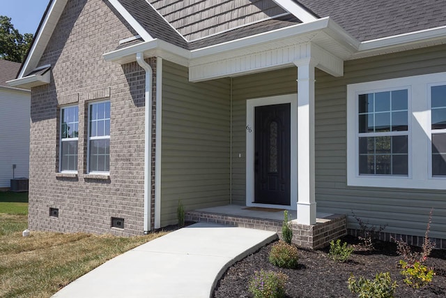 view of exterior entry with central AC unit and a porch