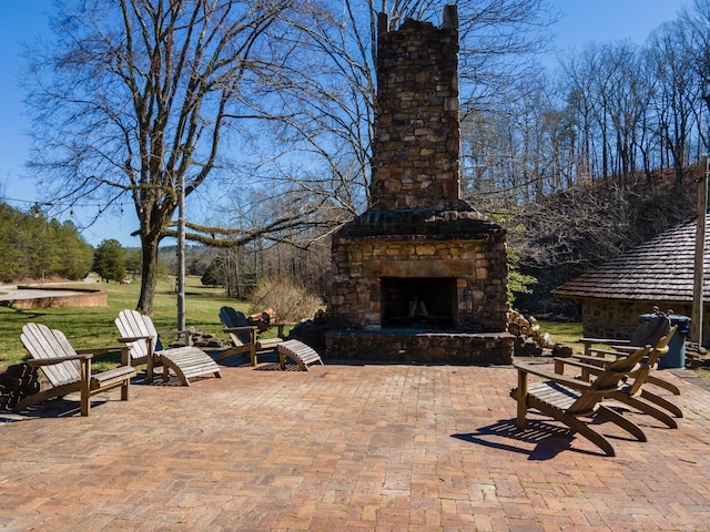 view of patio / terrace featuring an outdoor stone fireplace