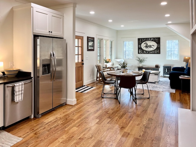 dining area featuring crown molding and light hardwood / wood-style floors