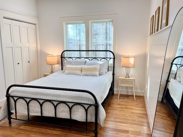 bedroom with hardwood / wood-style flooring and a closet