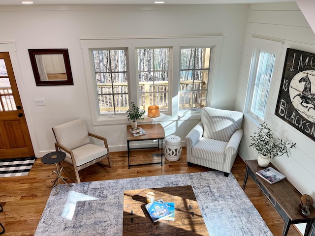 sitting room with wood-type flooring