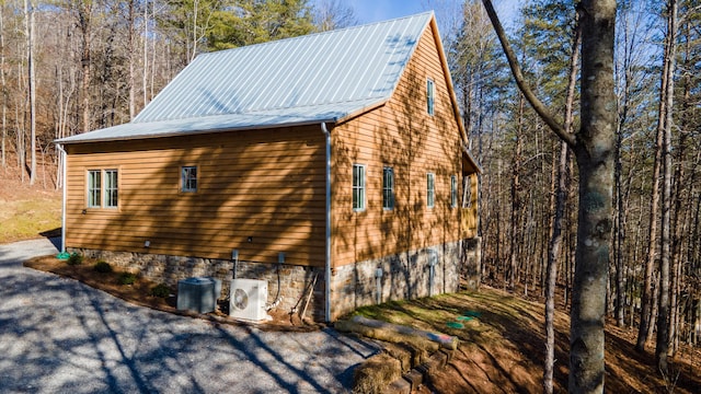 view of side of home with ac unit and cooling unit