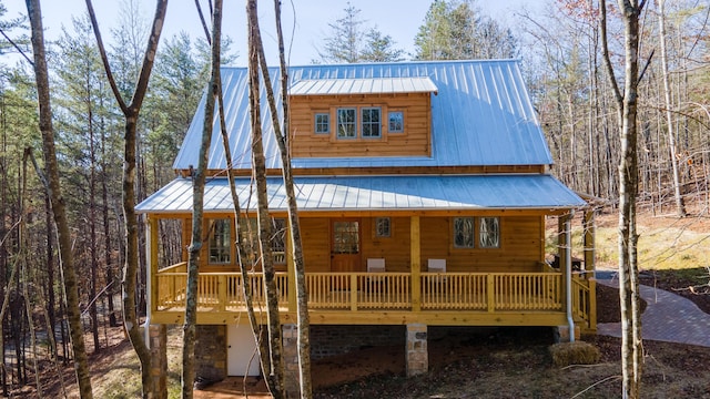 view of front of house featuring a wooden deck and covered porch