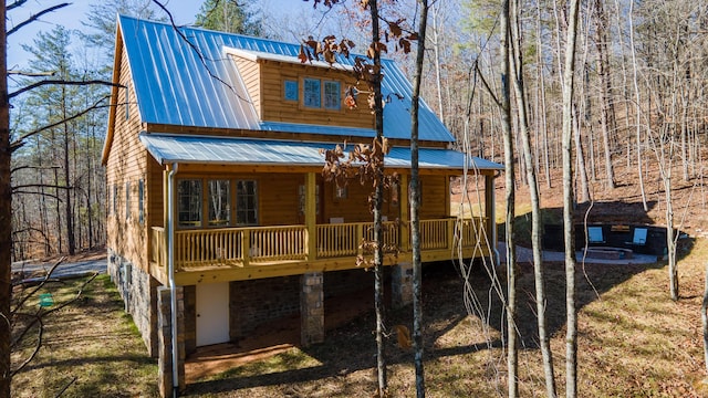 back of house with a fire pit