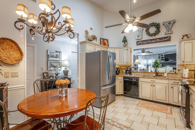 kitchen with a high ceiling, sink, appliances with stainless steel finishes, light stone counters, and tasteful backsplash