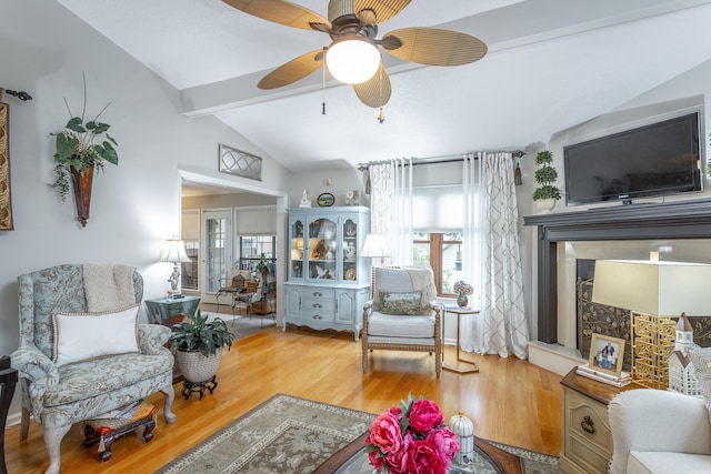 living room featuring lofted ceiling with beams, hardwood / wood-style flooring, and ceiling fan