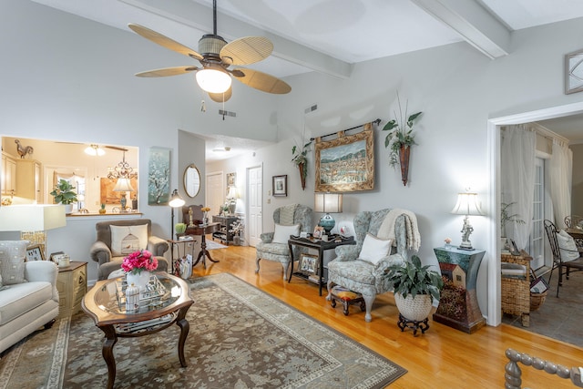 living room with beam ceiling, hardwood / wood-style flooring, and ceiling fan