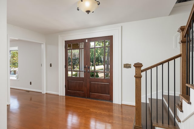 entrance foyer featuring hardwood / wood-style flooring and french doors