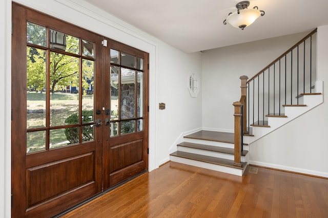 entrance foyer featuring hardwood / wood-style floors and french doors