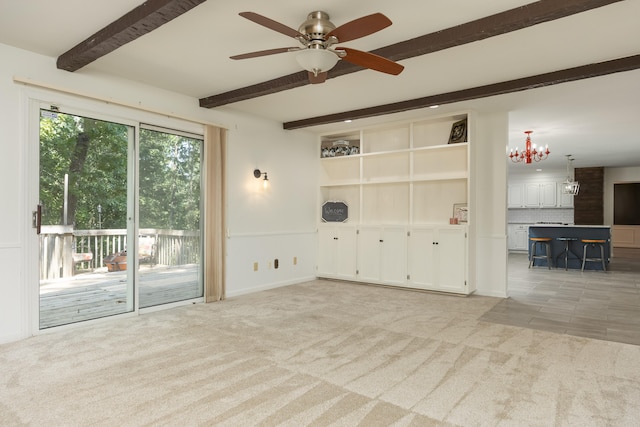 unfurnished living room with ceiling fan with notable chandelier, beamed ceiling, and light carpet