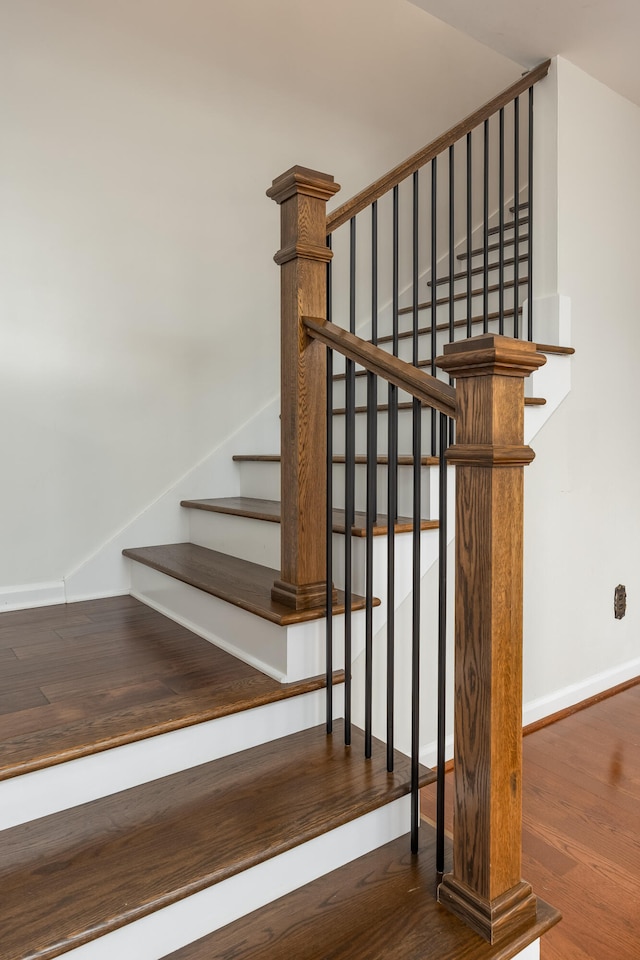 stairs featuring hardwood / wood-style flooring