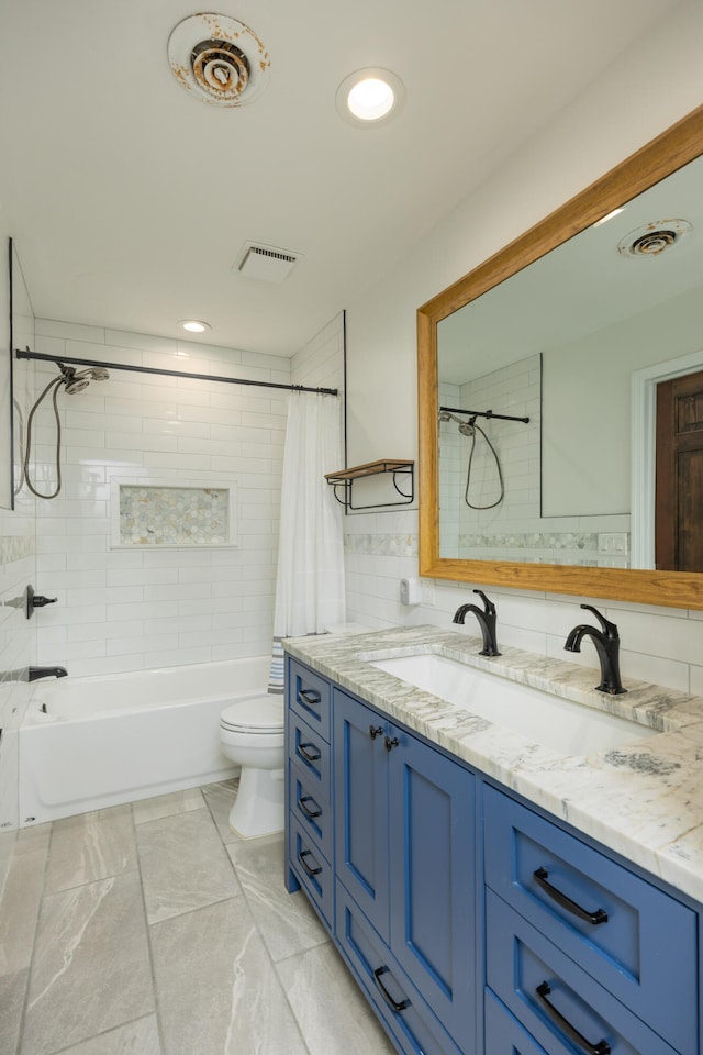 full bathroom featuring shower / tub combo, vanity, and toilet